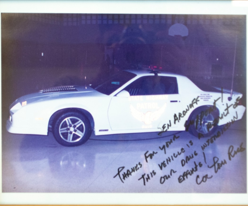 A signed image of a vehicle and a note to Senator Aronoff