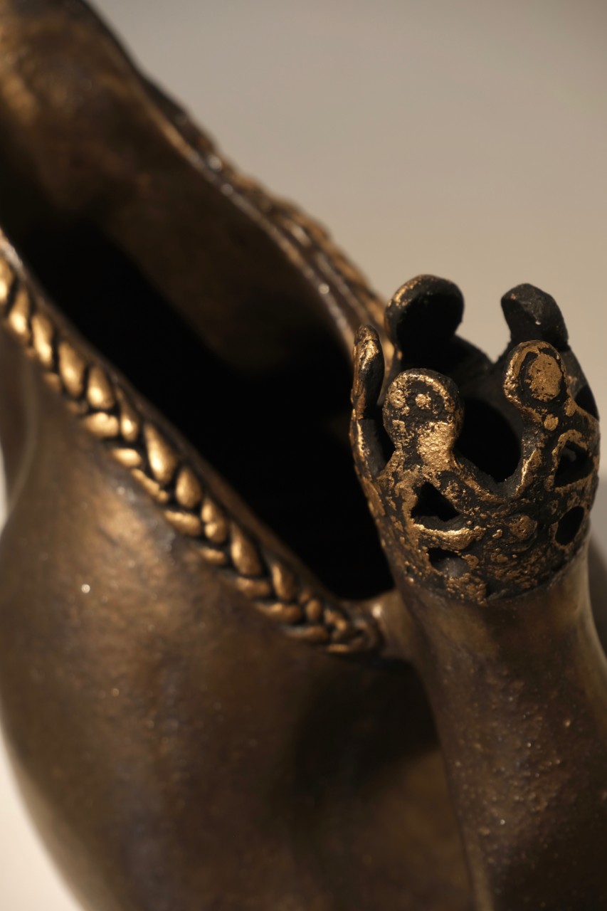 stoneware and metallic pouring vessel