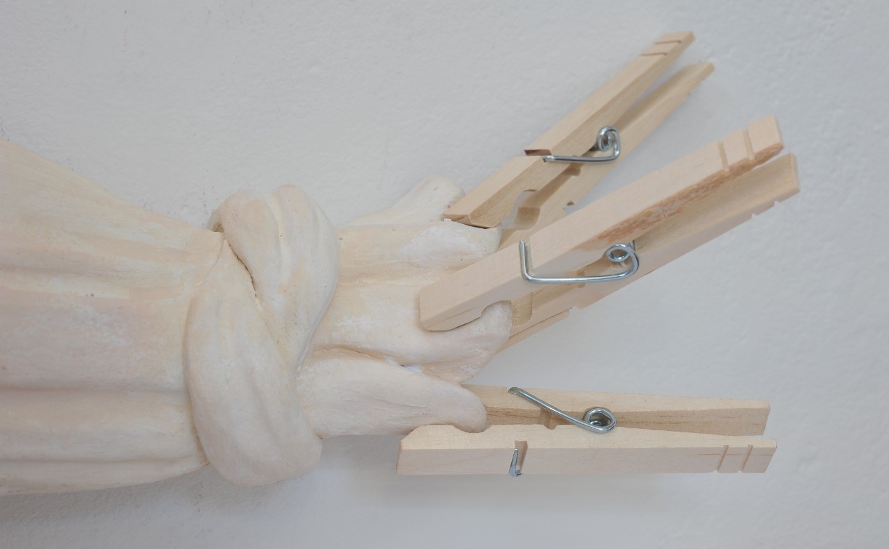 white stretched clay pinched by clothespins