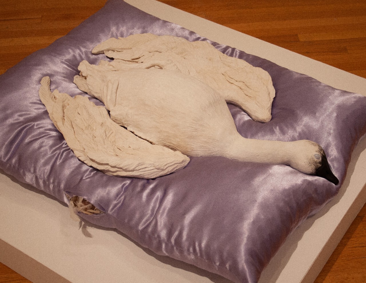 ceramic goose on pillow