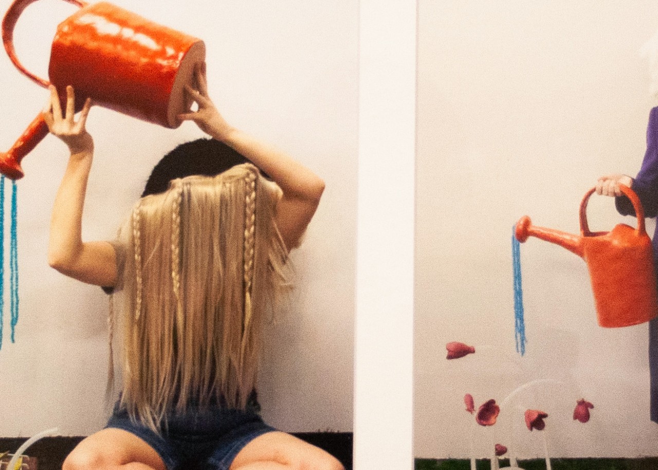 detail of figure with watering can and wig