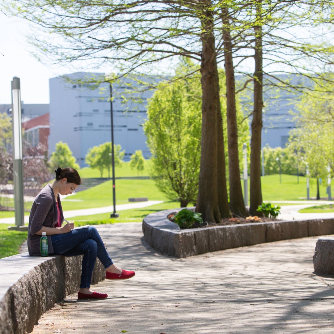 Students studying on her tablet at Sigma Sigma Commons. 